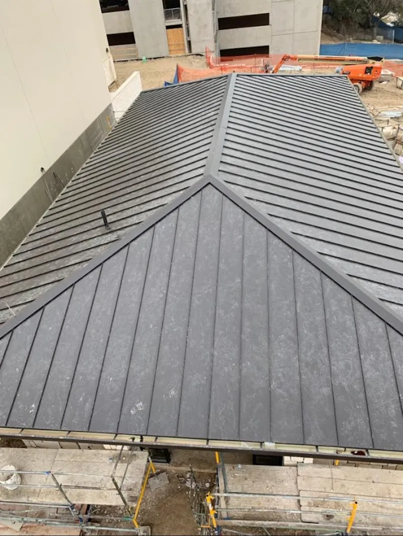 Commercial metal roof construction with crane equipment in Ringwood