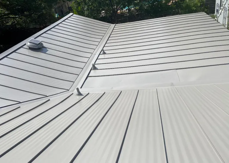Solar attic fan installed on a metal roof for Roof Ventilation in Ringwood